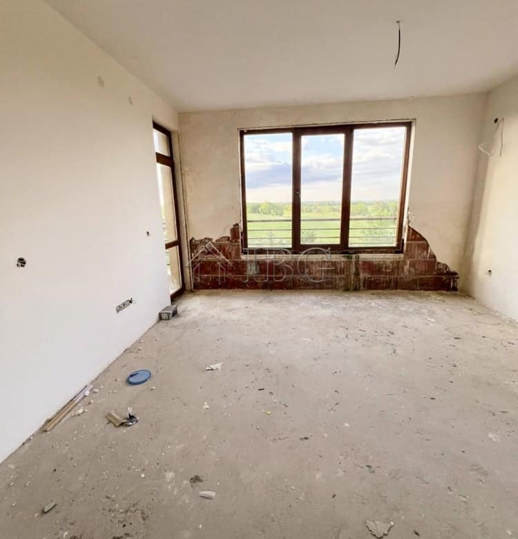 Apartment interior with large window overlooking scenic landscape in Balchik.