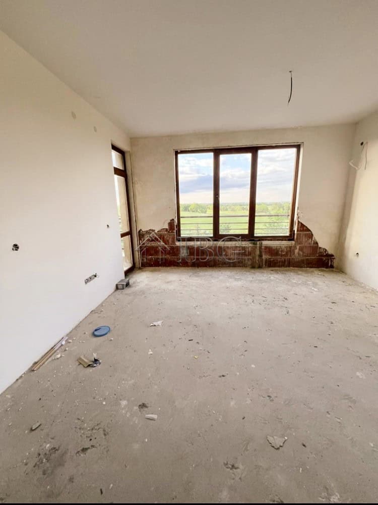 Apartment interior with large window overlooking scenic landscape in Balchik.