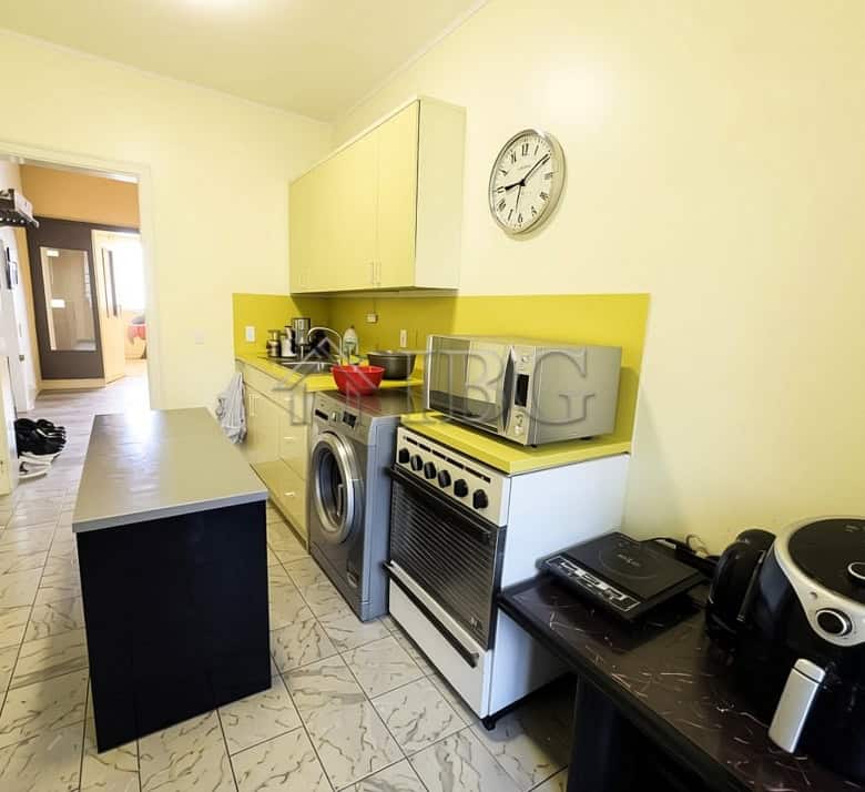 Bright kitchen with modern appliances and yellow accents in Ruse.