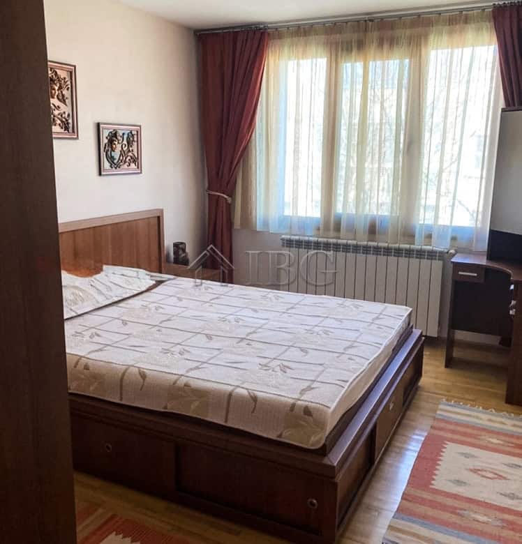 Spacious bedroom with large window, natural light, and comfortable furnishings. Ideal for rent near.