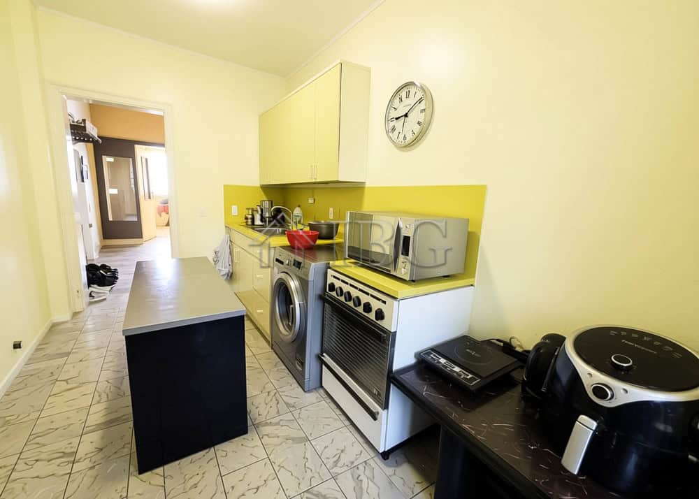 Bright kitchen with modern appliances and yellow accents in Ruse.