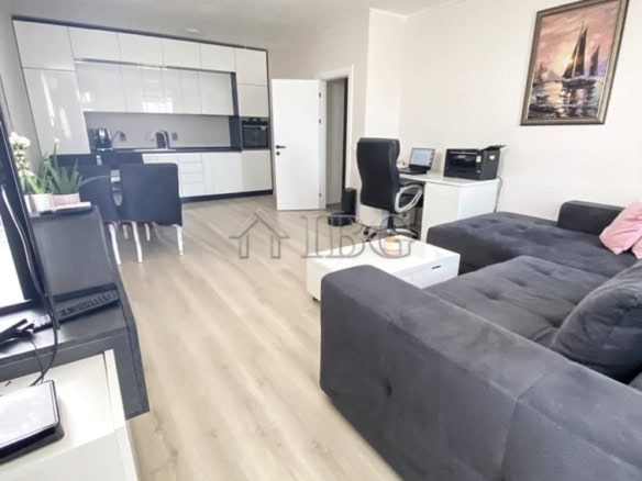 Spacious living room with open-plan kitchen, workspace, and contemporary decor at Lighthouse Golf &.