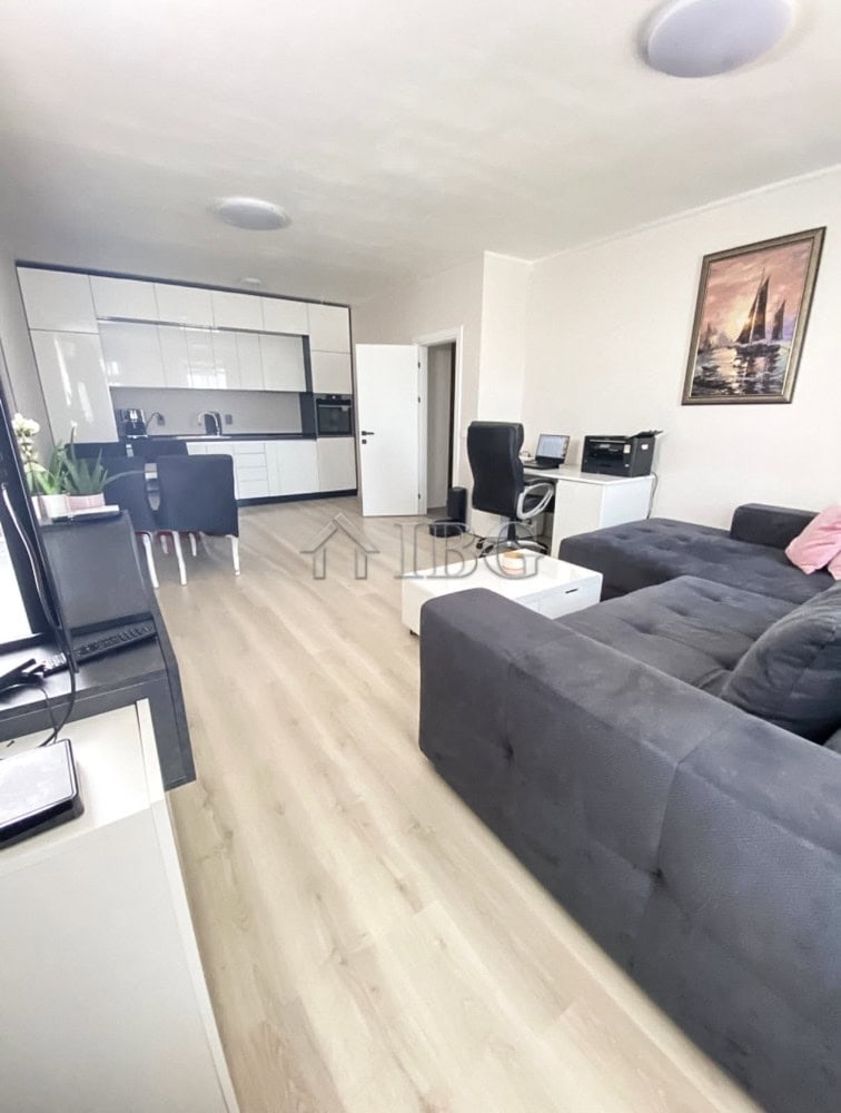 Spacious living room with open-plan kitchen, workspace, and contemporary decor at Lighthouse Golf &.