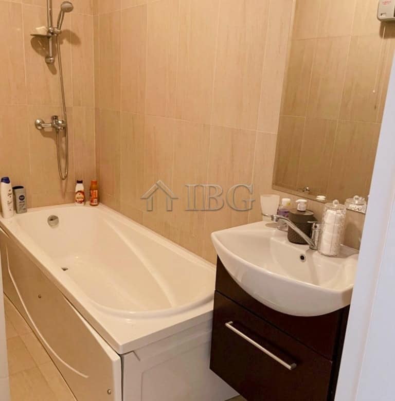 Bathroom with bathtub and sink in a spacious apartment for sale.