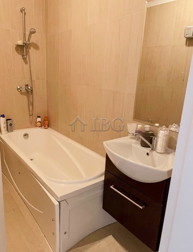 Bathroom with bathtub and sink in a spacious apartment for sale.