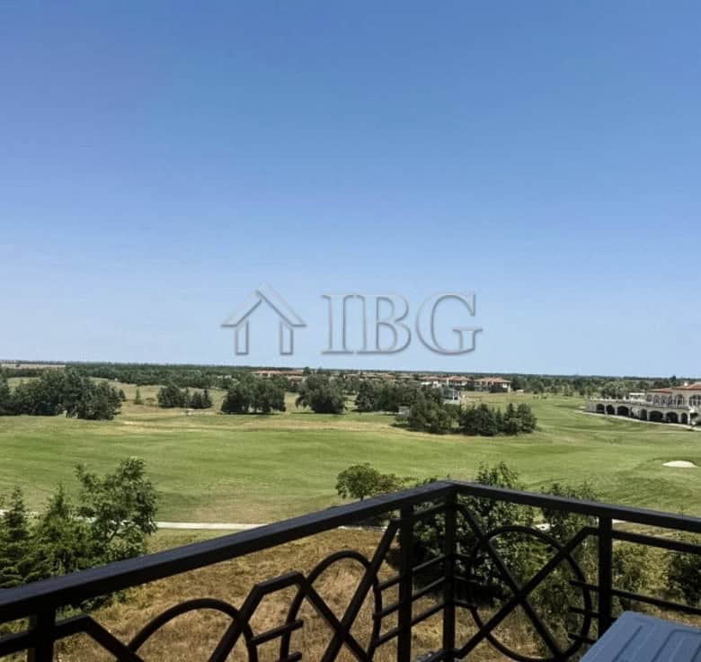 Golf view apartment balcony with lush green landscape and clear blue sky.