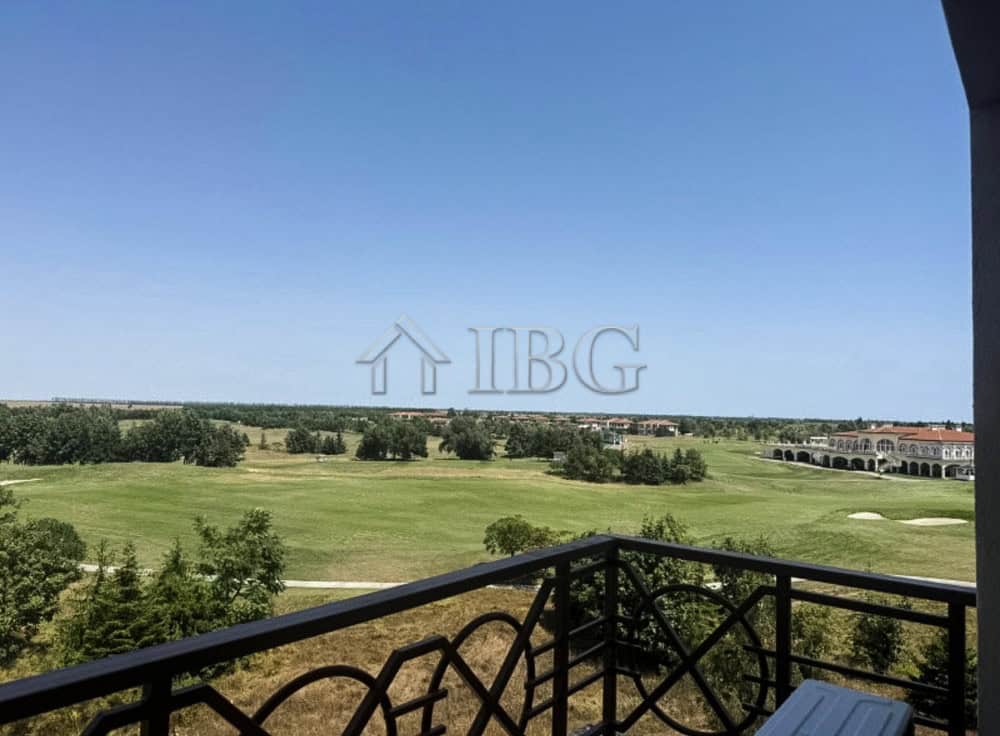 Golf view apartment balcony with lush green landscape and clear blue sky.