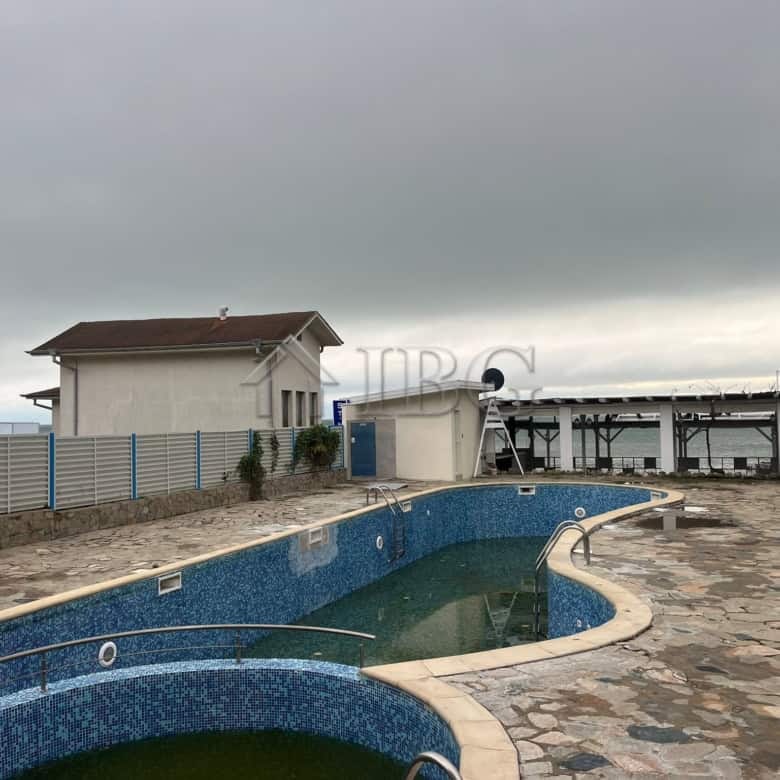 Outdoor swimming pool with mosaic tiles and surrounding stone deck in Sveti Vlas.