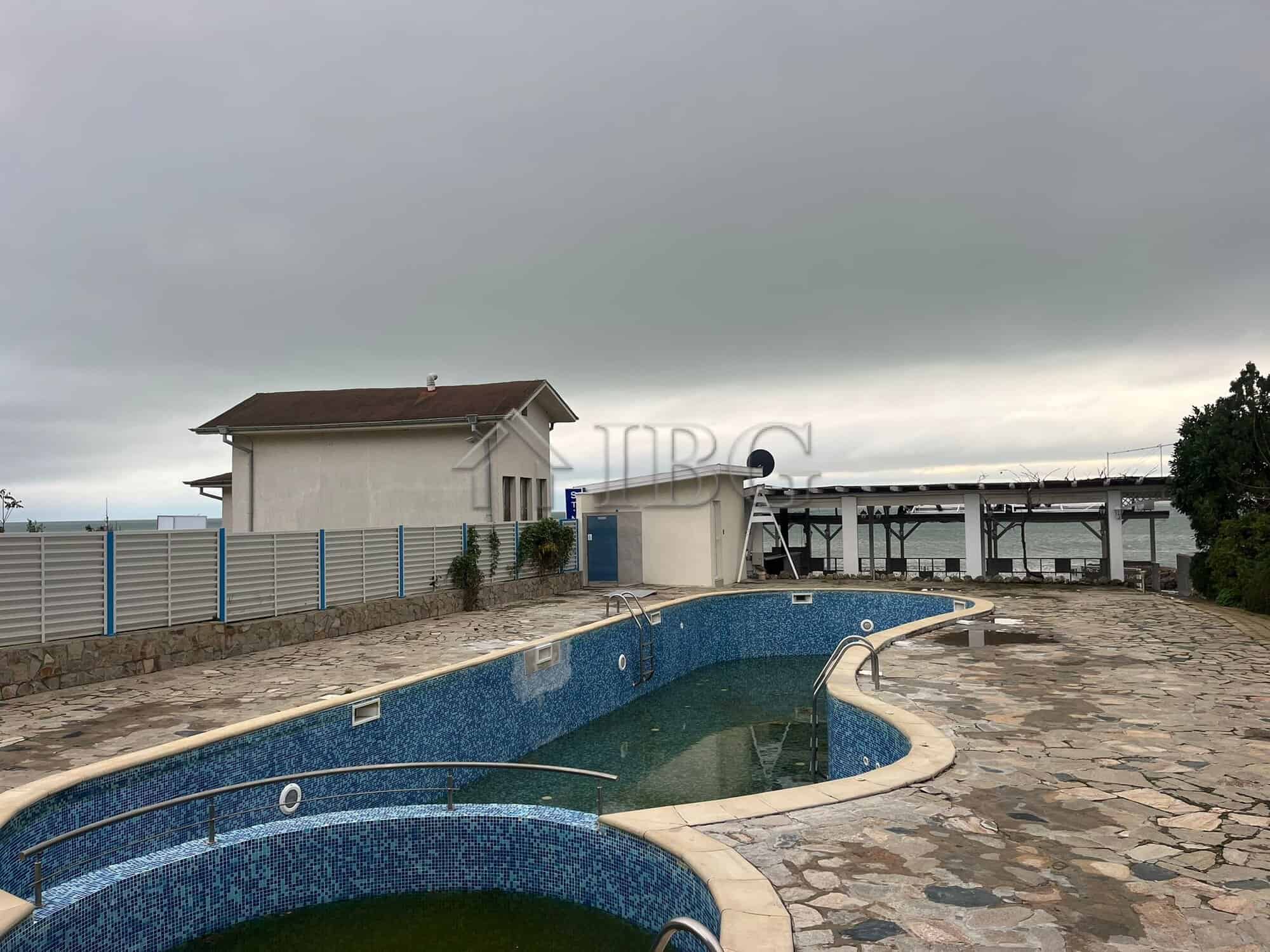Outdoor swimming pool with mosaic tiles and surrounding stone deck in Sveti Vlas.