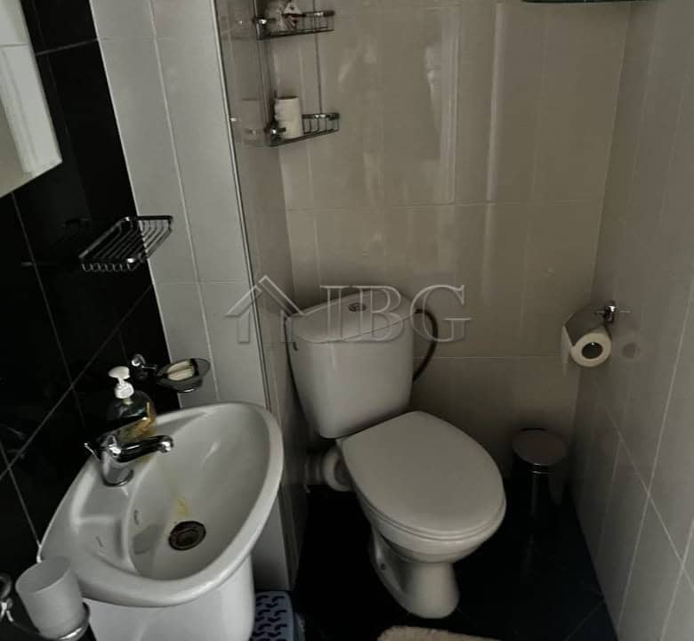Compact bathroom featuring a sink, toilet, and shower in Sveti Vlas property.