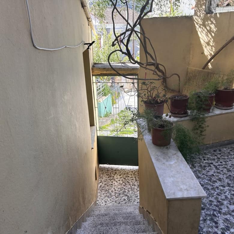 Outdoor terrace with potted plants and garden scenery, perfect for relaxing or gardening activities.