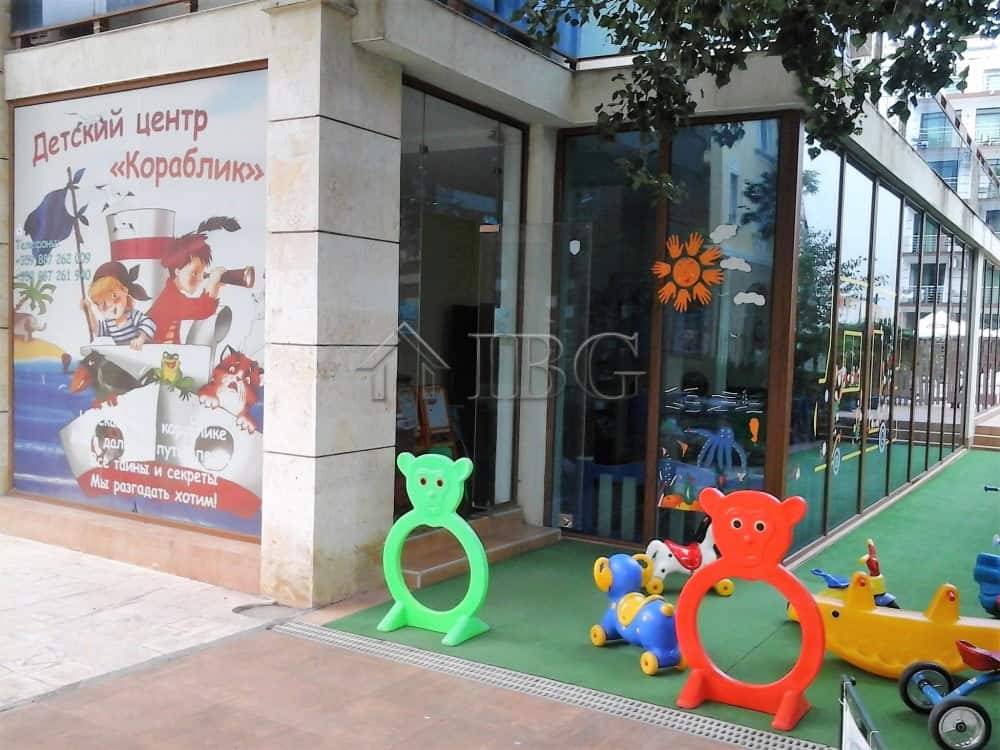 Playground with colorful bear-shaped and animal-themed ride-on toys for kids.