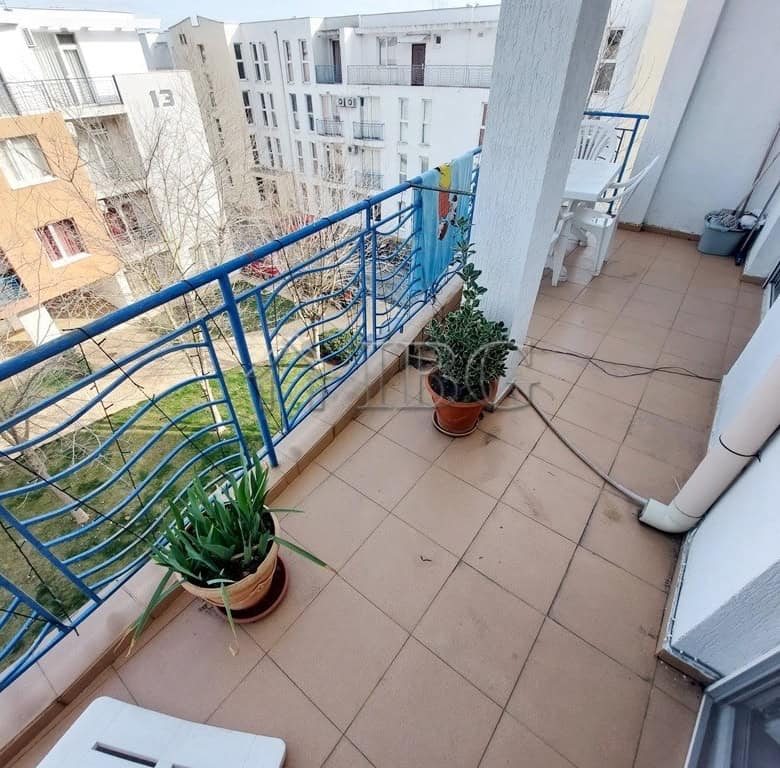 Balcony with potted plants and outdoor furniture in a sunny apartment in Sunny Beach.