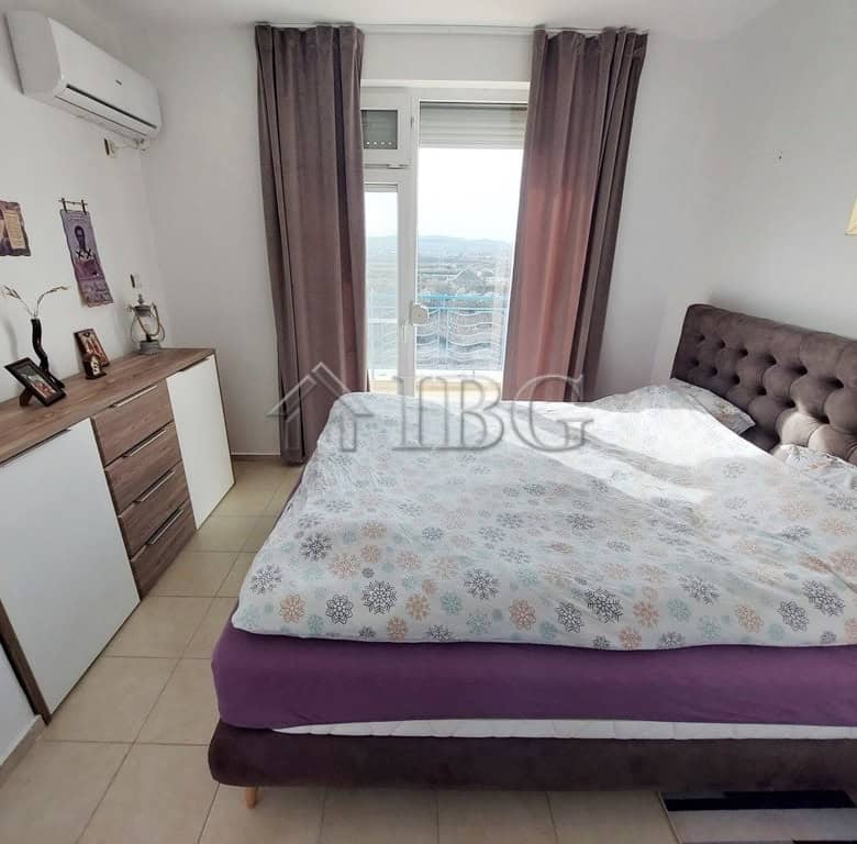 Spacious bedroom with a large bed and scenic balcony view in Sunny Day 3 complex.