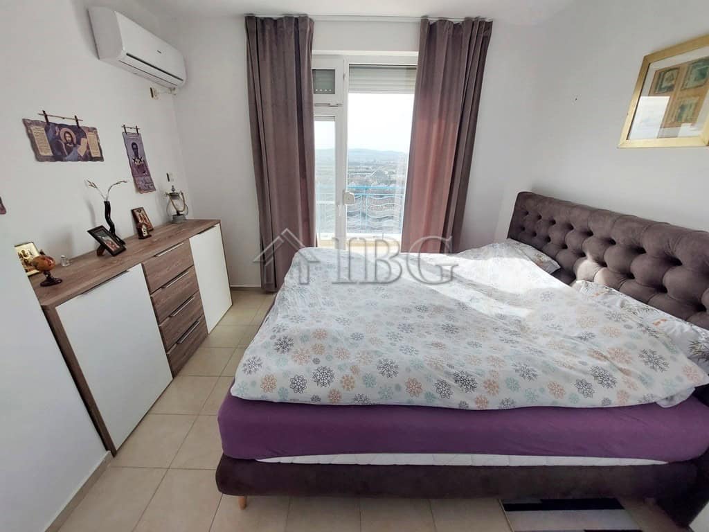 Spacious bedroom with a large bed and scenic balcony view in Sunny Day 3 complex.