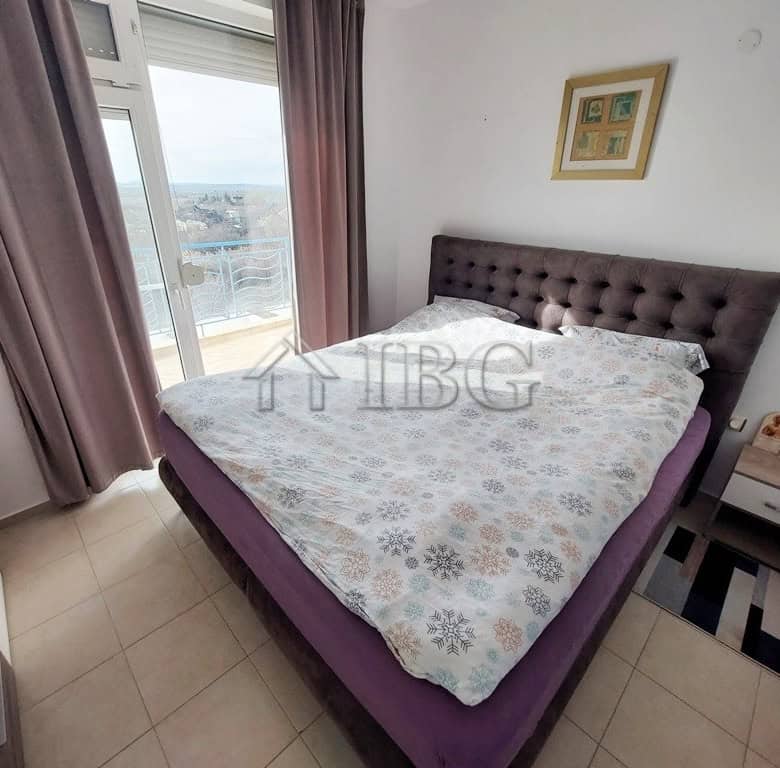 Bright bedroom with large window and balcony view in Sunny Day 3 complex, Sunny Beach.