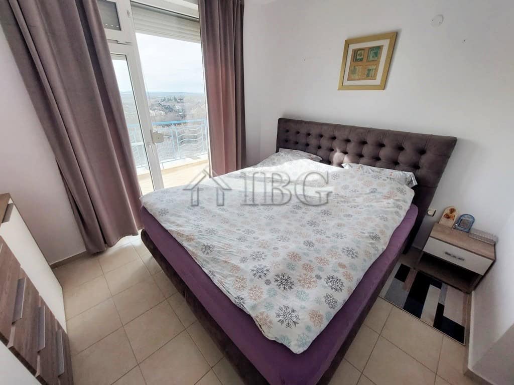 Bright bedroom with large window and balcony view in Sunny Day 3 complex, Sunny Beach.
