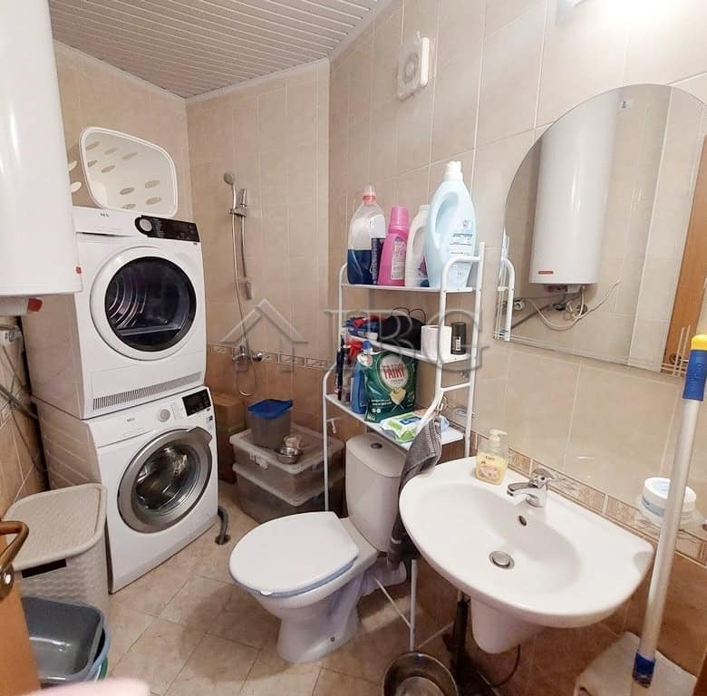 Bright bathroom with washing machine and laundry area in Sunny Beach.