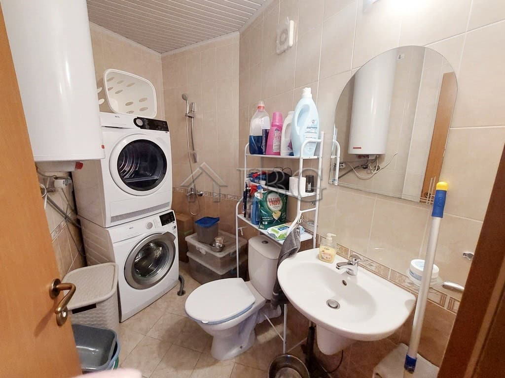 Bright bathroom with washing machine and laundry area in Sunny Beach.