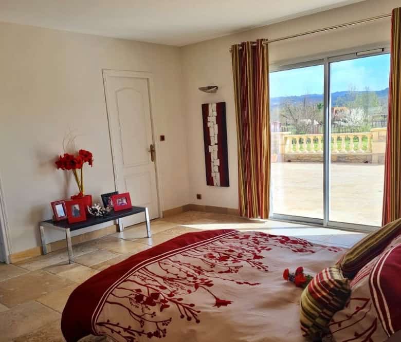 Elegant bedroom with large windows and scenic views in Dordogne Valley.