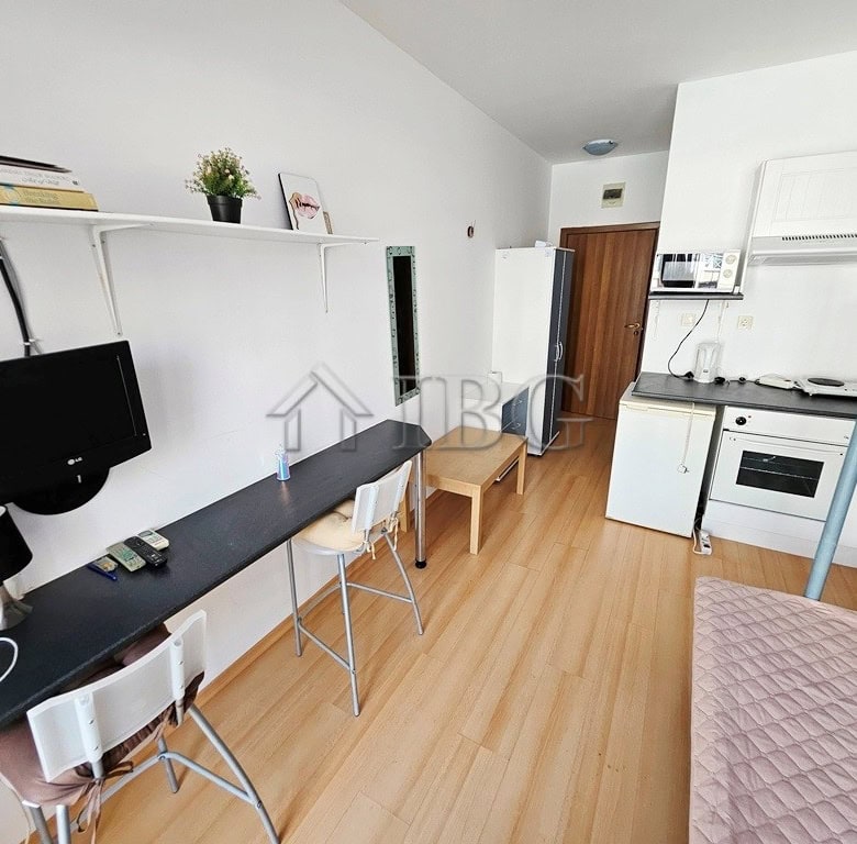 Cozy studio apartment with balcony overlooking pool, perfect for sunny beach stays. Compact living s.