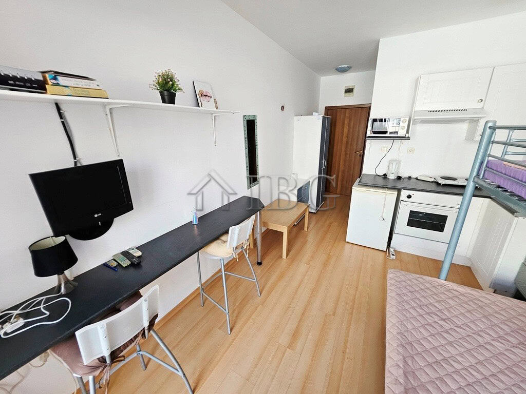 Cozy studio apartment with balcony overlooking pool, perfect for sunny beach stays. Compact living s.