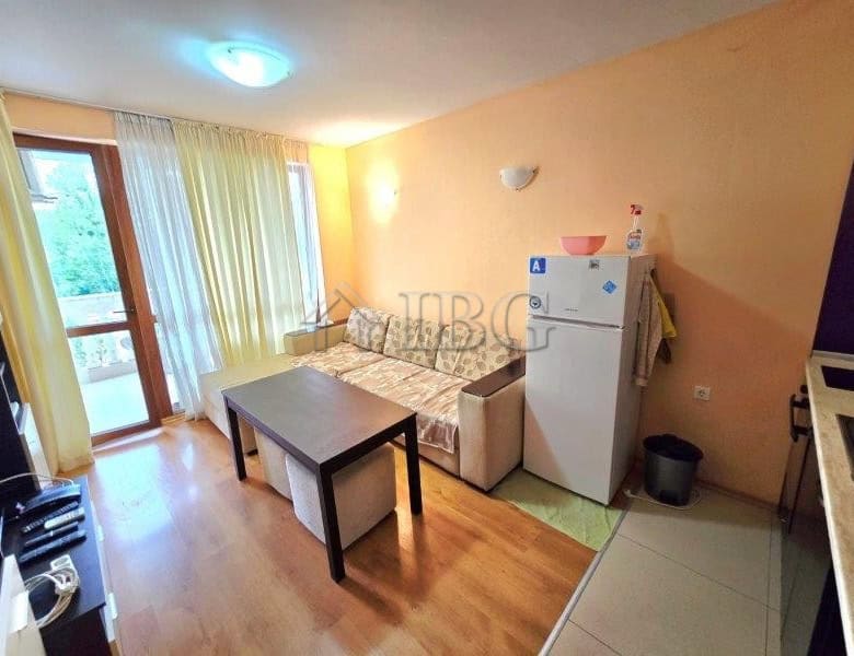 Bright apartment with pool view, living area, and kitchenette in Sunny Beach. Perfect for a comforta.