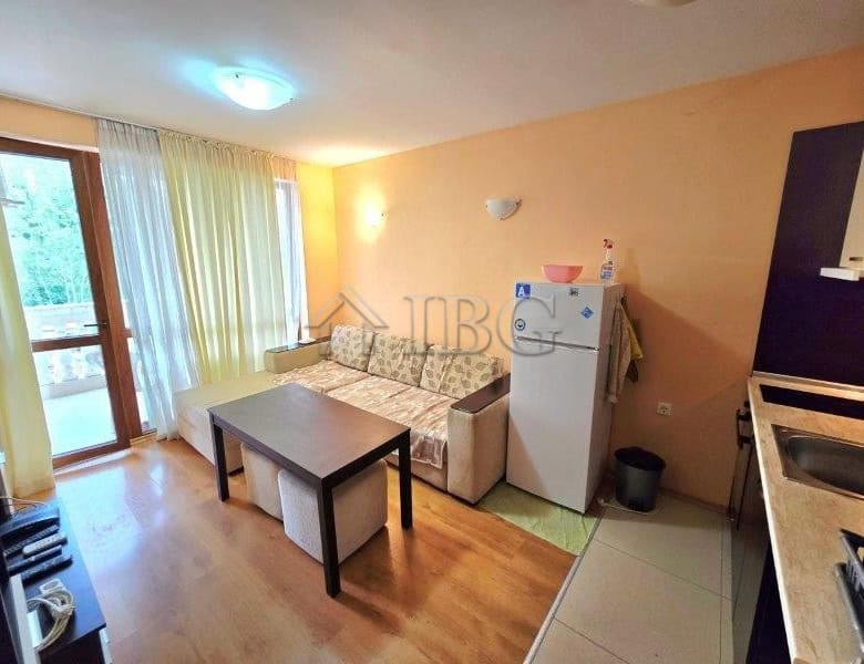 Bright apartment with a pool view, featuring a living room, small dining area, and balcony access.