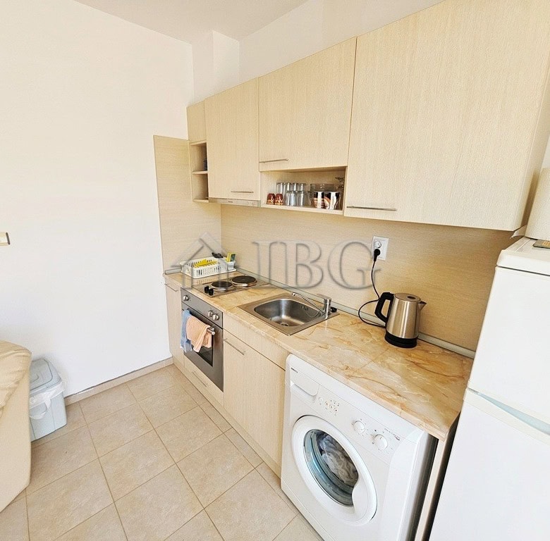 Bright kitchen with modern appliances in Sunny Beach apartment.