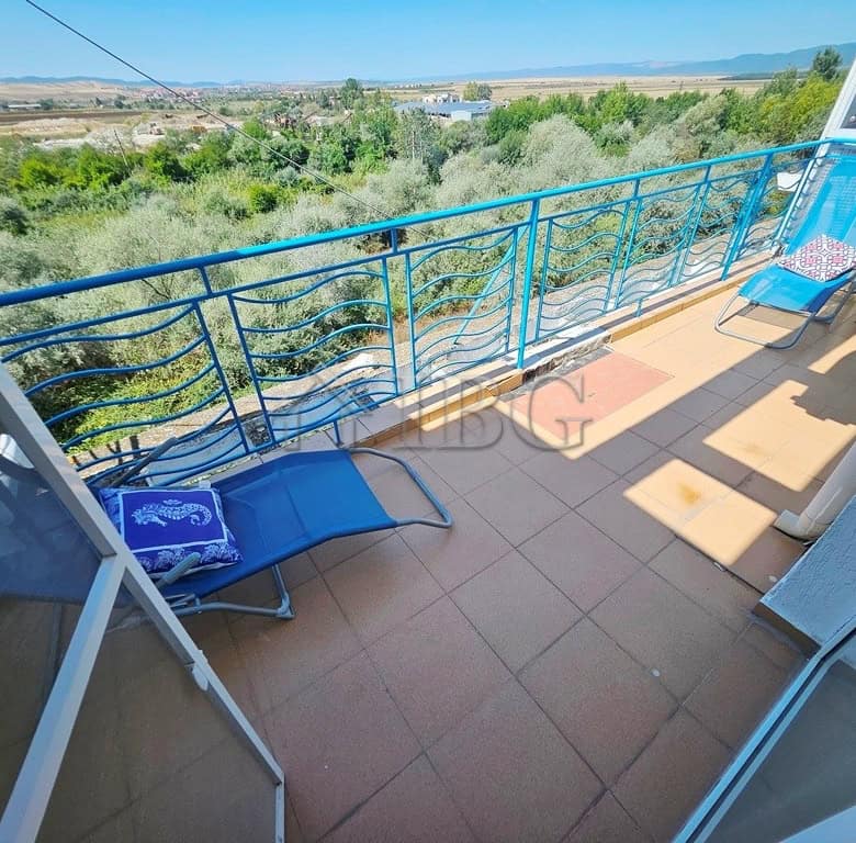 Balcony of a 2-bedroom maisonette apartment overlooking lush greenery and scenic landscape in Sunny.