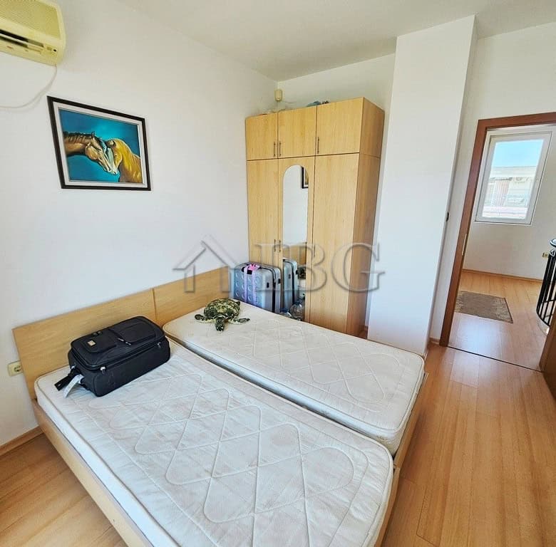 Bright bedroom with twin beds and wardrobe in Sunny Beach apartment.