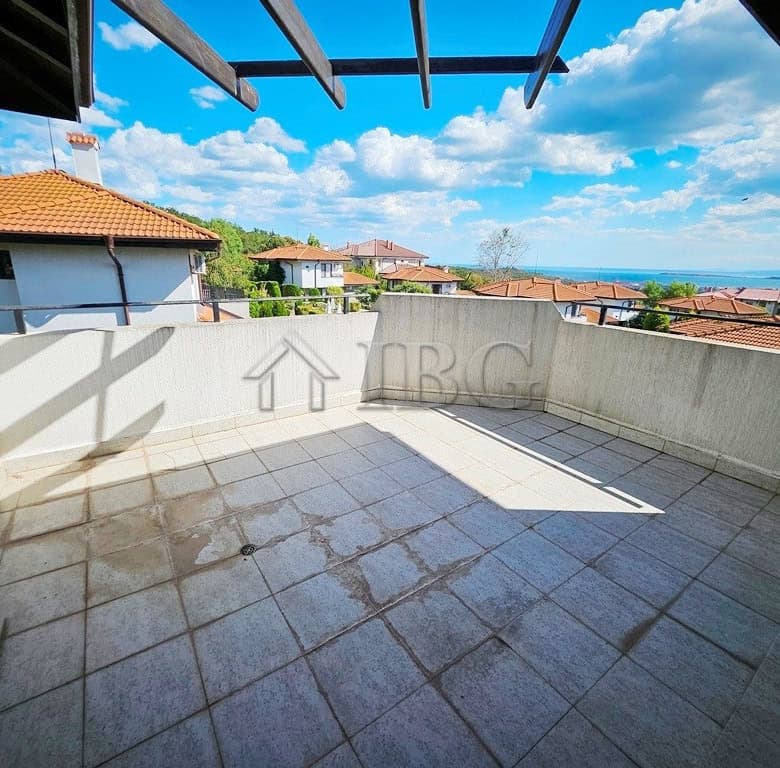 Balcony of a 1-bedroom apartment overlooking Sunny Beach and surrounding homes.