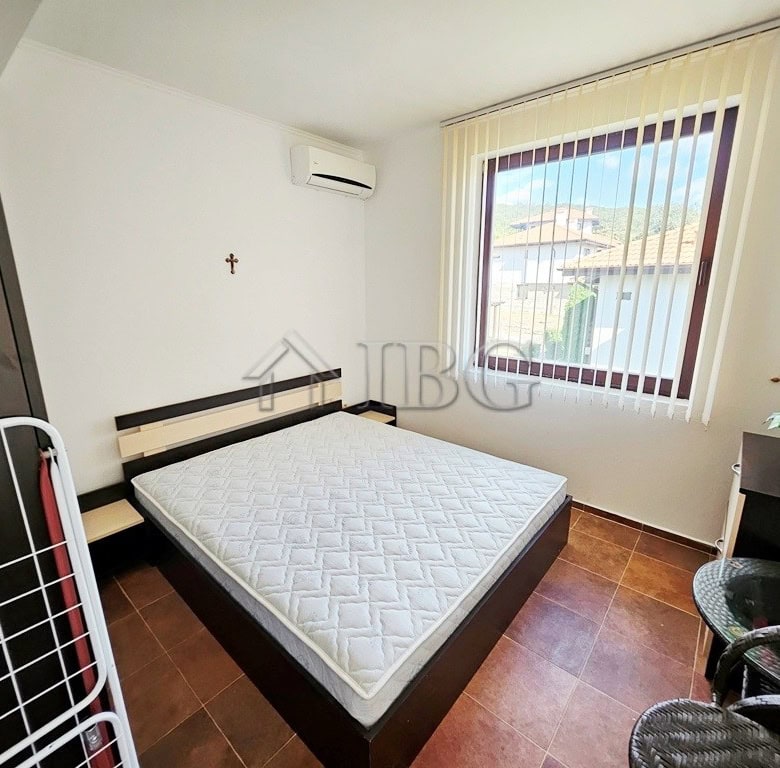 Comfortable bedroom with a large window and scenic views.
