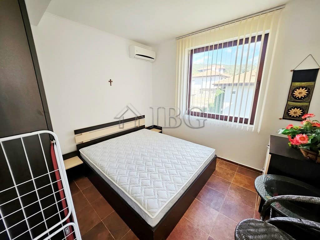 Comfortable bedroom with a large window and scenic views.