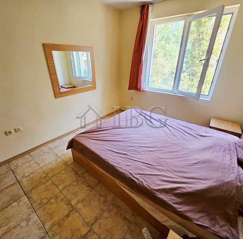 Comfortable bedroom with large window and pool view in Prestige City complex.
