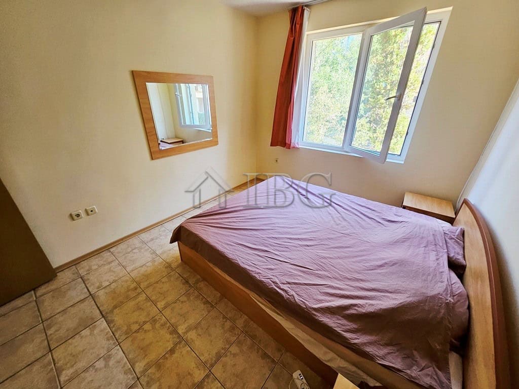 Comfortable bedroom with large window and pool view in Prestige City complex.