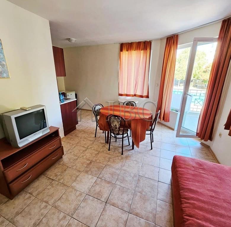 Bright 1-bedroom apartment with pool view, balcony, and modern furnishings in Sunny Beach.