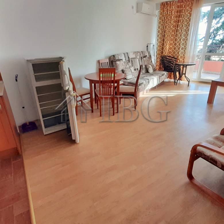 Bright living room with sea view, sofa, dining area, and balcony at Riviera Fort Beach.