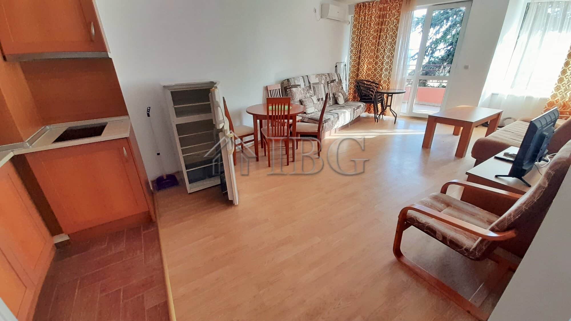Bright living room with sea view, sofa, dining area, and balcony at Riviera Fort Beach.