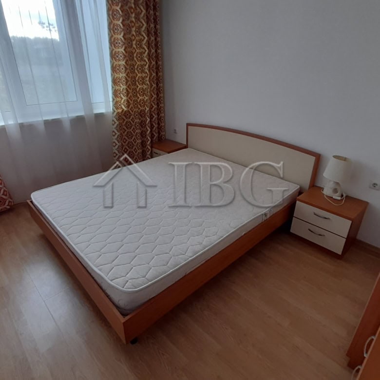 Cozy bedroom with sea view, large window, and wooden furniture at Riviera Fort Beach, Ravda.