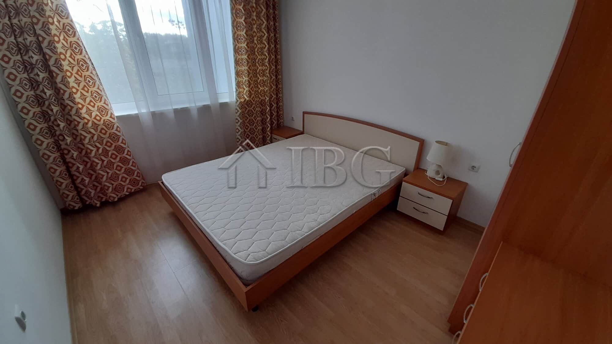 Cozy bedroom with sea view, large window, and wooden furniture at Riviera Fort Beach, Ravda.