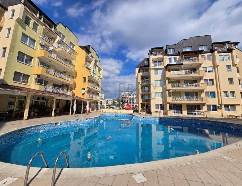 Pool view of the Sea Dreams complex in Sunny Beach, Bulgaria, with surrounding apartment buildings a.