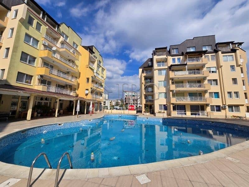 Pool view of the Sea Dreams complex in Sunny Beach, Bulgaria, with surrounding apartment buildings a.