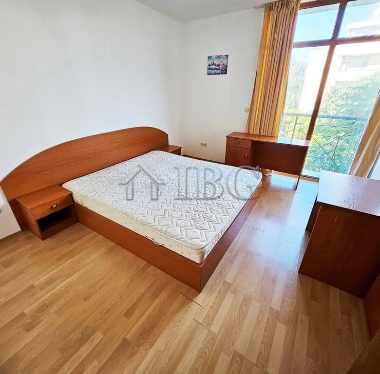 Bedroom with large window overlooking pool in Blue Summer Complex, Sunny Beach.