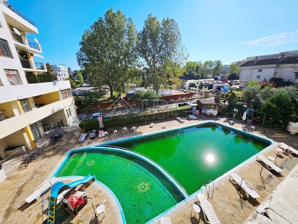 Modern Blue Summer Complex Pool in Sunny Beach Bright view of the pool at Blue Summer Complex with lush trees and surrounding apartments.