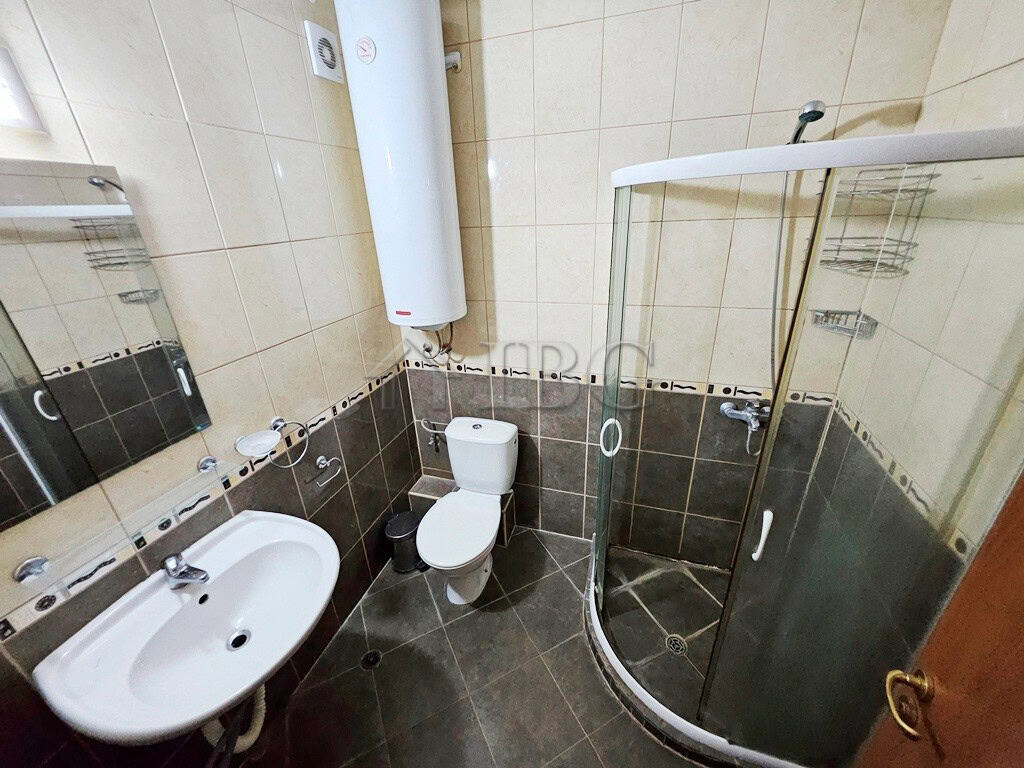 Bathroom with shower cabin in a modern apartment in Sunny Beach. Bathroom with shower cabin, toilet, and sink in a compact, modern apartment.