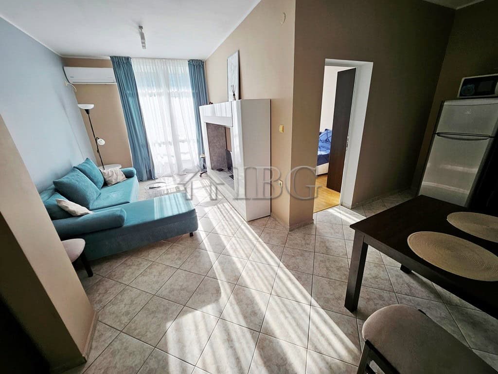 Modern 2-room apartment in Pirop City, Sunny Beach Bright living room with sofa and large windows in Pirop City, Sunny Beach.