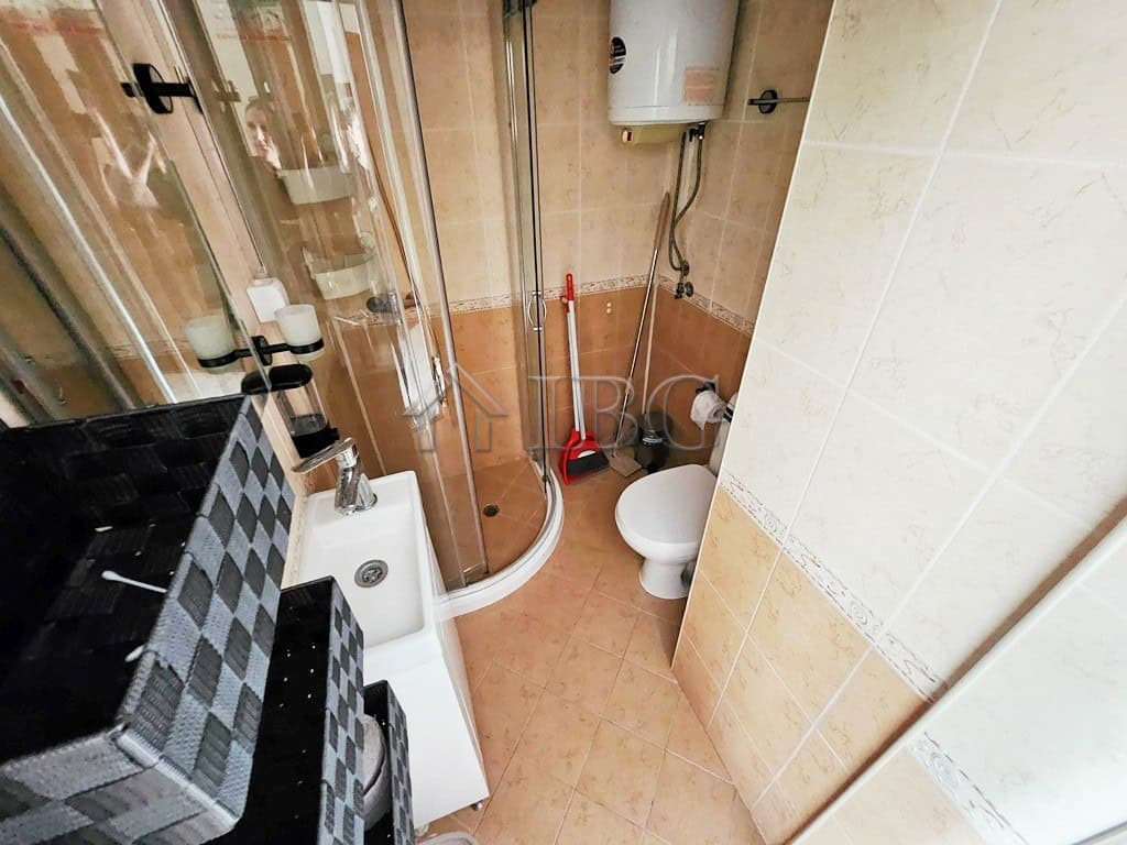Cozy 2-Room Apartment in Sunny Beach Small bathroom in a 2-room apartment in Pirop City, Sunny Beach, with shower, toilet, and sink.