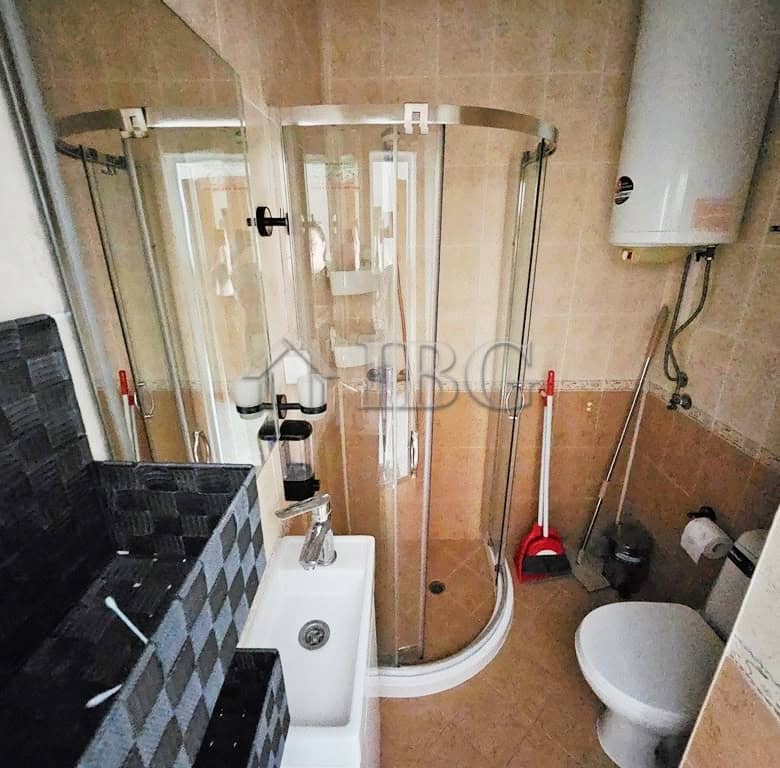 Compact bathroom with shower cabin and modern fixtures in Pirop City, Sunny Beach.