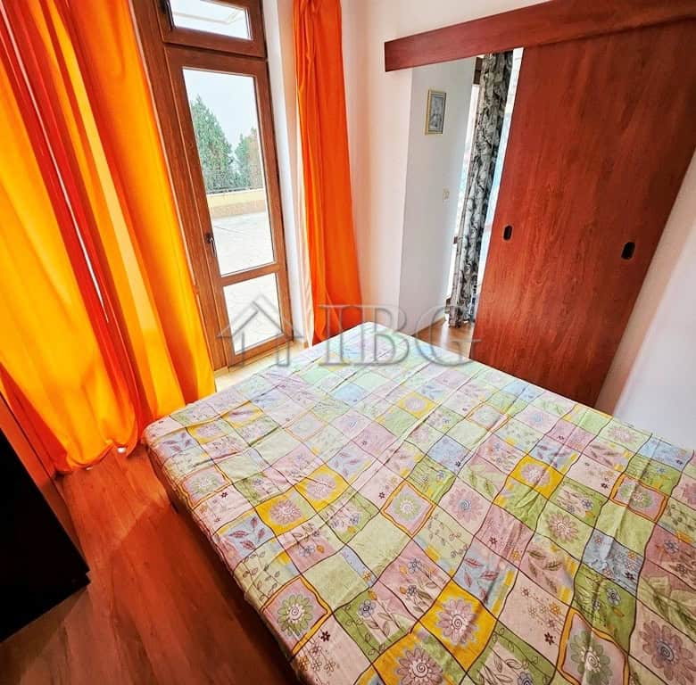 Bright 1-bedroom apartment with pool view, large windows, and colorful curtains in Sveti Vlas.